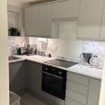 Freshly painted walls in a Modern grey Howdens kitchen with freshly painted walls.